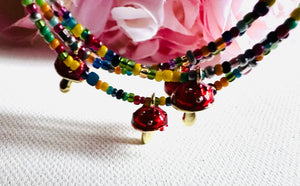 multicolor beads with a tiny gold and red enamel mushroom charm on beaded anklet.