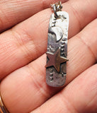 Gold Star and Moon Tag Necklace in a hand
