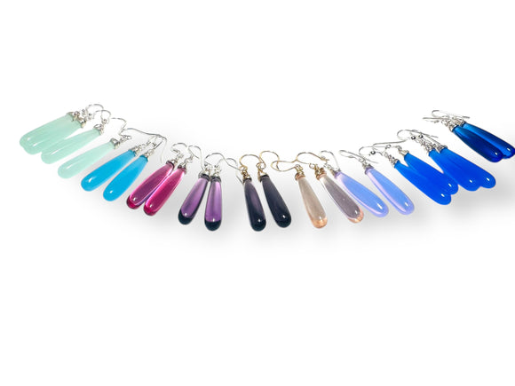 Colorful teardrop-shaped earrings on a white background