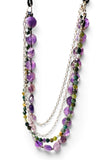 A multi-strand necklace featuring purple faceted beads, green and yellow stone beads, and silver chains, displayed on a clean white background.