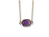 Necklace with a purple Amethyst gemstone pendant on a white background