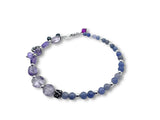 Beaded bracelet with purple and blue beads on a white background, Amethyst and Tanzanite charm bracelet