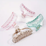 Set of four colorful hair clips on a white background