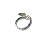 Silver ring with a leaf design on a white background