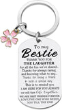 Keychain with engraved message to 'Bestie' featuring a pink flower charm on a white background