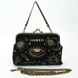Black handbag with celestial designs on a white background