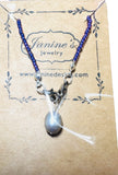 Necklace with a pendant on a Janine's Jewelry branded card