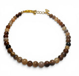 Beaded bracelet with gold clasp on a white background