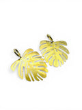 Two gold leaf-shaped Earrings on a white background