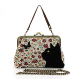 Handbag with floral pattern and black cat design on a white background