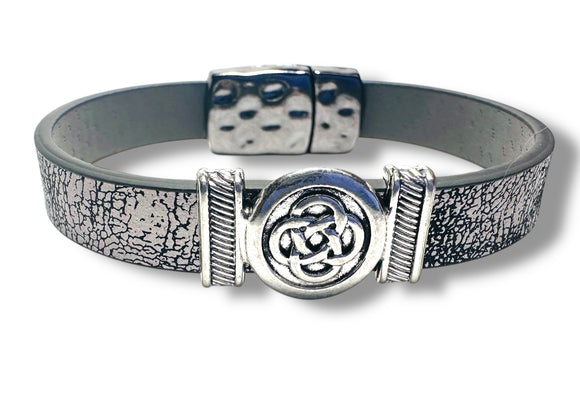 Bracelet with gray leather strap and silver Celtic knot design on a white background