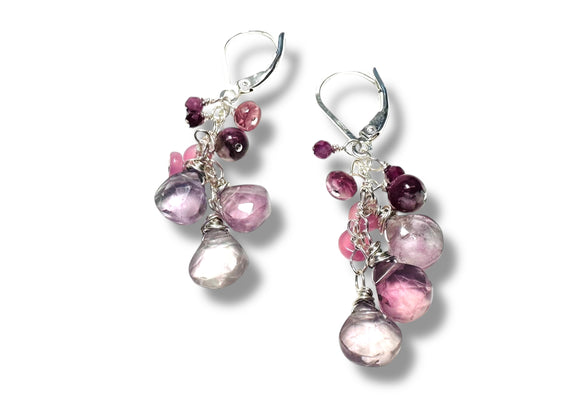 Pair of earrings with pink and purple beads on a white background