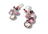Pair of earrings with pink and purple gemstones on a white background
