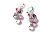 Pair of earrings with pink and purple beads on a white background