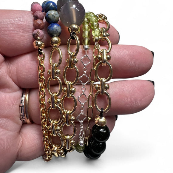 Assortment of chain accent stretch gemstone bracelets. Size shown against a hand.