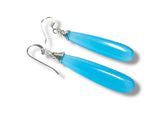 Pair of blue teardrop earrings with silver hooks on a white background