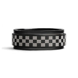 Black ring with a checkered pattern on a white background