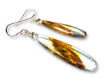 Teardrop-shaped earrings with brown and clear design on a white background