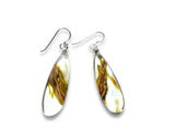 Teardrop-shaped earrings with tortoiseshell pattern on a white background