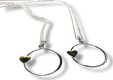 Two silver necklaces with heart-shaped pendants on a white background