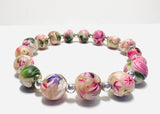 Bracelet with floral-patterned beads on a white background