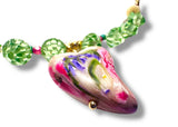 Colorful beaded necklace with a decorative pendant on a white background
