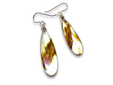 Teardrop-shaped earrings with tortoiseshell pattern on a white background