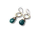 Pair of earrings with gold loops and teal beads on a white background
