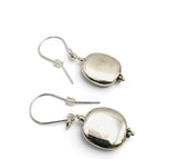 A pair of polished silver drop earrings with smooth, rounded teardrop-shaped pendants and fishhook wires, displayed on a clean white background.