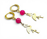 Gold hoop earrings with flamingo charms and pink beads on a white background