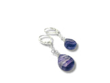 Pair of purple teardrop earrings on a white background