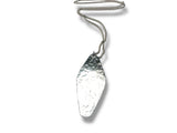 Silver necklace with a textured pendant on a white background