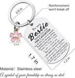 Keychain with engraved message and pink flower charm, featuring dimensions and material details.