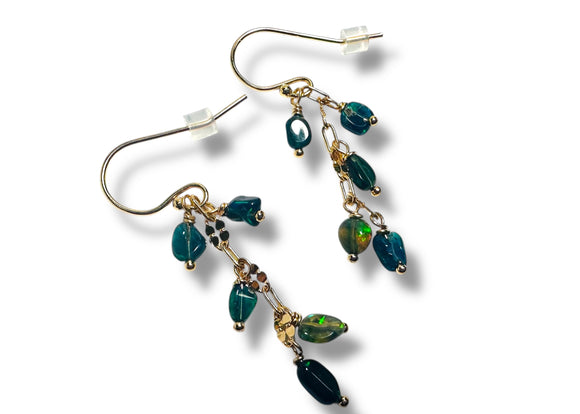 Pair of green beaded earrings on a white background