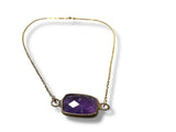 Necklace with a purple Amethyst gemstone pendant on a white background