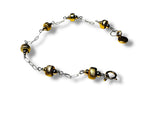 Bracelet with gold and silver beads on a white background