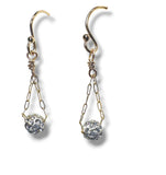 Gold and silver earrings on a white background