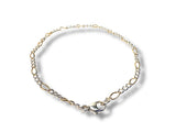 Gold and silver chain bracelet on a white background