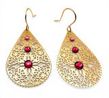 Gold filigree earrings with red gemstones on a white background
