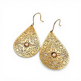 Gold filigree earrings with a central gemstone on a white background
