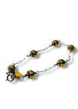 Bracelet with yellow and black beads on a white background