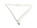 Gold necklace with a pearl pendant on a white background