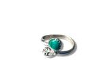 Silver ring with a turquoise stone on a white background