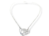 Silver necklace with interlocking heart pendants on a white background