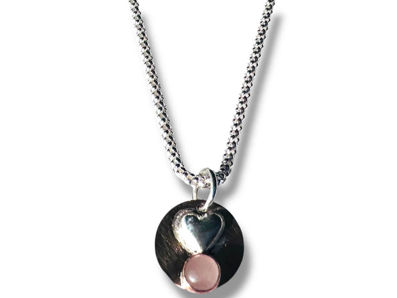 Necklace with a heart and pink stone pendant on a white background