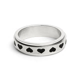 Silver ring with black heart patterns on a white background