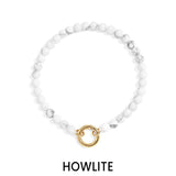 White beaded bracelet with a gold clasp on a white background, labeled 'Howlite'.