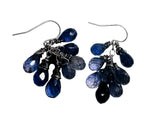 Pair of blue teardrop earrings on a white background