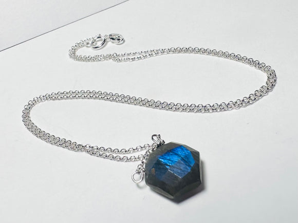 Necklace with a blue pendant on a white background