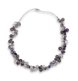 Beaded necklace with purple and clear beads on a white background